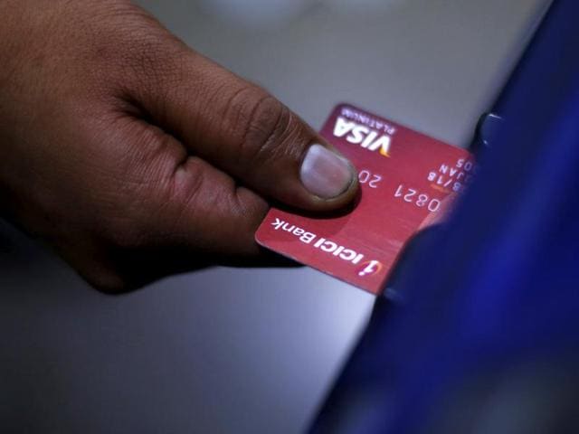 REFILE - CORRECTING HEADLINE A man uses an ICICI automated teller machine (ATM) in New Delhi, India, March 5, 2016. REUTERS/Adnan Abidi/File Photo (REUTERS) REFILE - CORRECTING HEADLINE A man uses an ICICI automated teller machine (ATM) in New Delhi, India, March 5, 2016. REUTERS/Adnan Abidi/File Photo (REUTERS)