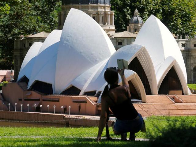 A woman takes a selfie in front of a model of the Sydney Opera House. (REUTERS) A woman takes a selfie in front of a model of the Sydney Opera House. (REUTERS)