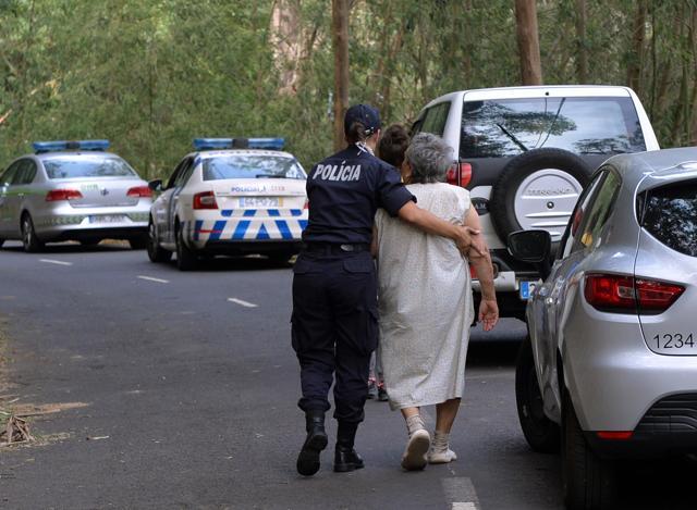 A policewoman escorts an elderly woman being evacuated as a fire approaches Curral dos Romeiros, on the outskirts of Funchal, the capital of the Madeira island, Portugal. (AP) A policewoman escorts an elderly woman being evacuated as a fire approaches Curral dos Romeiros, on the outskirts of Funchal, the capital of the Madeira island, Portugal. (AP)