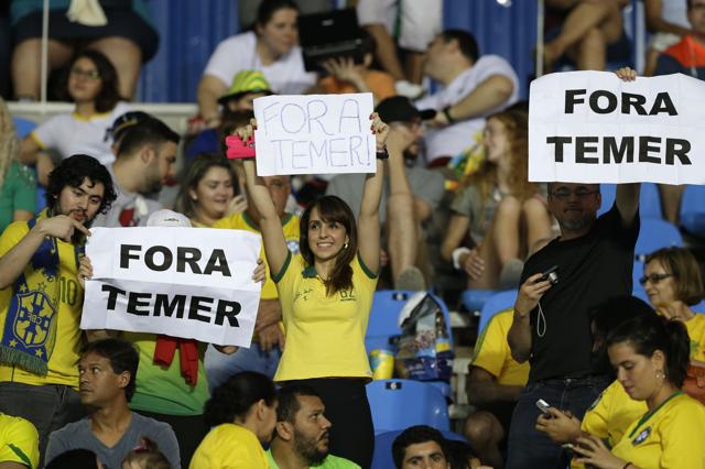 Fans at Rio’s Olympic Stadium hold up signs that read in Portuguese; "Temer Out," refering to Brazil’s interim president, Michel Temer. (AP) Fans at Rio’s Olympic Stadium hold up signs that read in Portuguese; "Temer Out," refering to Brazil’s interim president, Michel Temer. (AP)