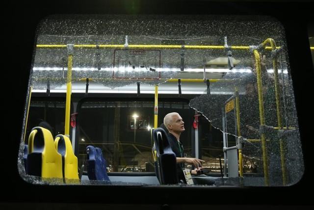 A journalist sits is seen in the official media bus after a window was shattered when driving accredited journalists to the Deodoro venue of the Rio 2016 Olympic Games . (REUTERS photo) A journalist sits is seen in the official media bus after a window was shattered when driving accredited journalists to the Deodoro venue of the Rio 2016 Olympic Games . (REUTERS photo)
