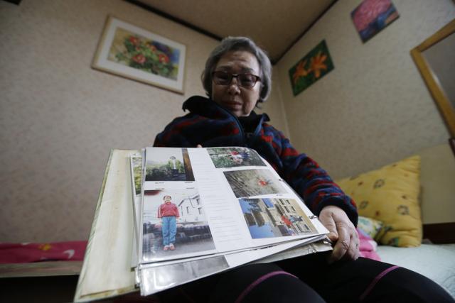 Song Bok-ja shows photographs of her son during an interview at her house in Busan, South Korea. (AP Photo) Song Bok-ja shows photographs of her son during an interview at her house in Busan, South Korea. (AP Photo)