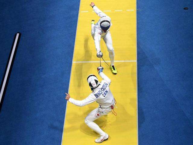 Canada's Maxime Brinck-Croteau (down) competes against Russia's Vadim Anokhin during the men’s individual epee qualifying bout, as part of the fencing event. (AFP) Canada's Maxime Brinck-Croteau (down) competes against Russia's Vadim Anokhin during the men’s individual epee qualifying bout, as part of the fencing event. (AFP)