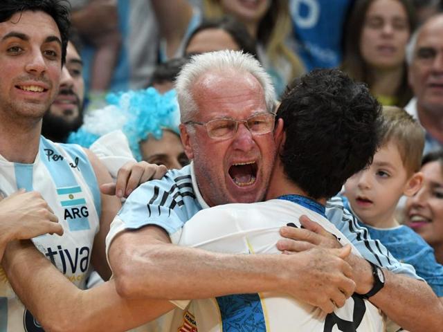 Argentina's Demian Gonzalez is hugged by a fan after his team won the men's qualifying volleyball match between Russia and Argentina at the Maracanazinho stadium. (AFP) Argentina's Demian Gonzalez is hugged by a fan after his team won the men's qualifying volleyball match between Russia and Argentina at the Maracanazinho stadium. (AFP)