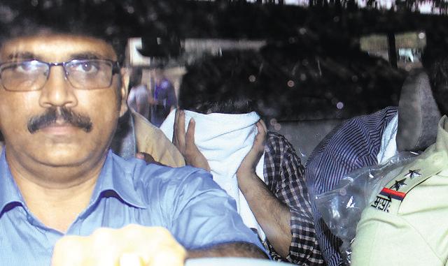 Another accused doctor ( face covered) in the kidney racket . (Pramod Thakur/HT Photo)