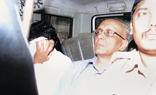 Dr Sujit Chatterjee, CEO of LH Hiranandani Hospital, is taken away by the police after his arrest. (Pramod Thakur/ HT photo)