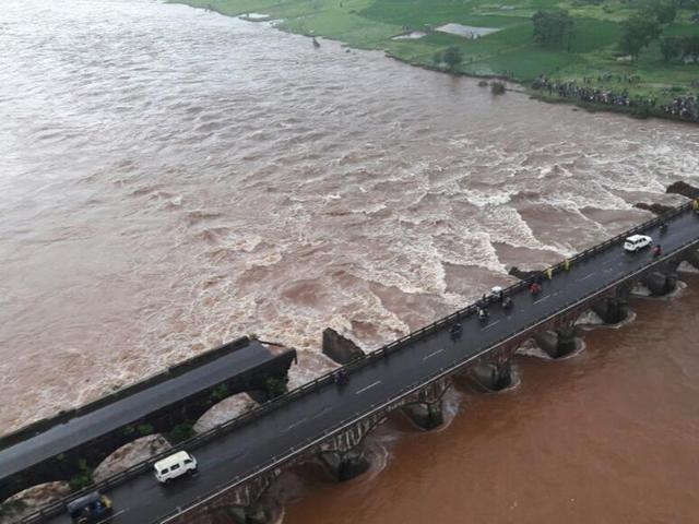 Mahad, India - August 3, 2016: An old bridge connecting to the Mumbai-Goa highway collapsed and was washed away by the Savitri river late on Tuesday night. Authorities believe 10 vehicles might have fallen into the river.