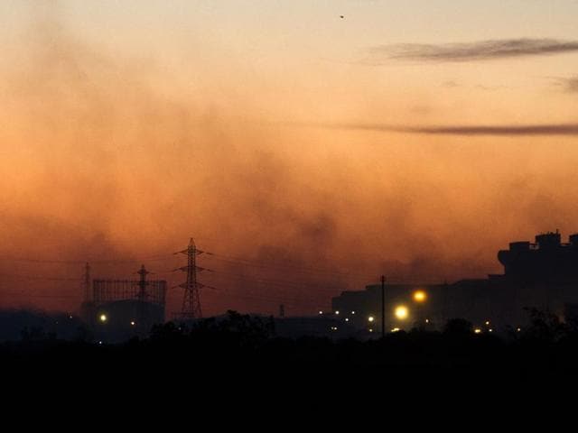 Smoke rises over an industrial area in southern France. coming from a fire that spread above the highway near Vitrolles. Residents of several districts in Vitrolles were evacuated.(AFP)