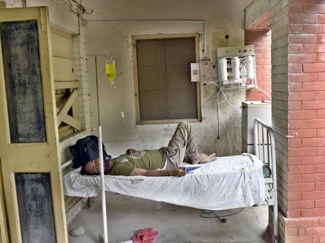 A patient lying in the corridors of the hospital on Tuesday. (Gurpreet Singh/HT Photo)