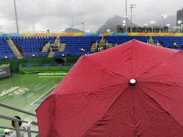 “It’ll stop raining anytime now. Hold on, where is everyone?” (AP)