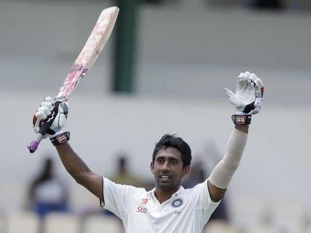 Ravichandran Ashwin celebrates after his century against West Indies. His teammate Wriddhiman Saha too scored a ton.(AP)