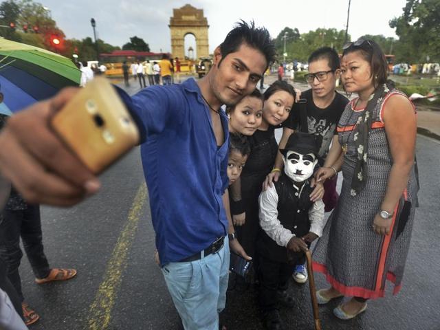 Work is seemingly simple: posing for photographs with enthusiastic tourists thronging India Gate. He charges Rs.10-20 for every selfie shot with him. Most are more than glad to pay for this unique opportunity, but there are some who don't honour their commitment, refusing to pay after getting photos clicked. (Raj K Raj/HT PHOTO)