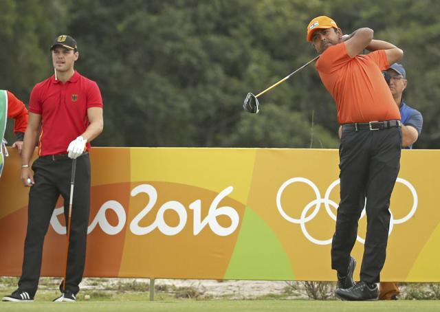 Anirban Lahiri of India hits his tee shot as Martin Kaymer of Germany looks on during the first round of the men's Olympic golf competition in Rio on Thursday. (REUTERS) Anirban Lahiri of India hits his tee shot as Martin Kaymer of Germany looks on during the first round of the men's Olympic golf competition in Rio on Thursday. (REUTERS)