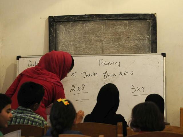 In this photo an arts graduate teaches multiplication to 20 students of Class 3. (Waseem Andrabi / HT Photo)