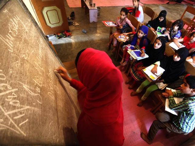 In this photo a volunteer is teaching mathematics to students. (Waseem Andrabi / HT Photo)