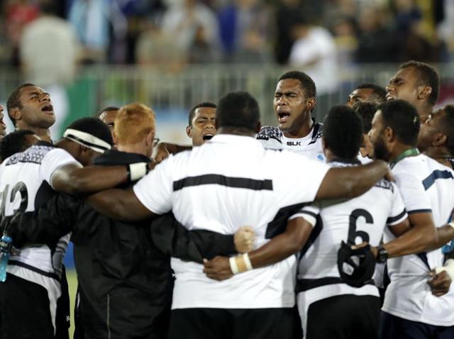 Vatemo Ravouvou, Viliame Mata, and Semi Kunatani, of Fiji, pose with fans after winning the gold medal match against Britain in the men’s rugby sevens. (AP Photo) Vatemo Ravouvou, Viliame Mata, and Semi Kunatani, of Fiji, pose with fans after winning the gold medal match against Britain in the men’s rugby sevens. (AP Photo)