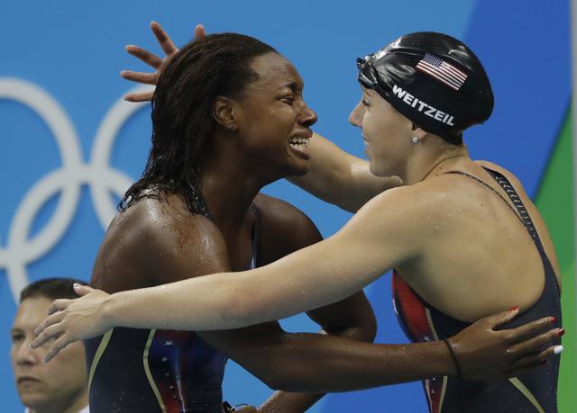 United States' Abbey Weitzeil, right, congratulates United States' Simone Manuel after winning the gold medal and setting a new olympic record in the women's 100-meter freestyle. (AP) United States' Abbey Weitzeil, right, congratulates United States' Simone Manuel after winning the gold medal and setting a new olympic record in the women's 100-meter freestyle. (AP)
