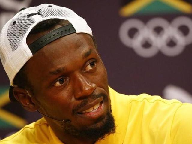 Usain Bolt gestures during a Jamaican Olympic Association and Puma press conference at the Cidade Das Artes in Rio de Janeiro on August 8, 2016. / AFP PHOTO / Adrian DENNIS(AFP Photo)