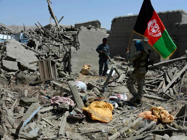 An Afghan security force member walks holding the national flag after government forces took full control of a village from Islamic State fighters during a military operation in Kot district. (AFP File Photo) An Afghan security force member walks holding the national flag after government forces took full control of a village from Islamic State fighters during a military operation in Kot district. (AFP File Photo)