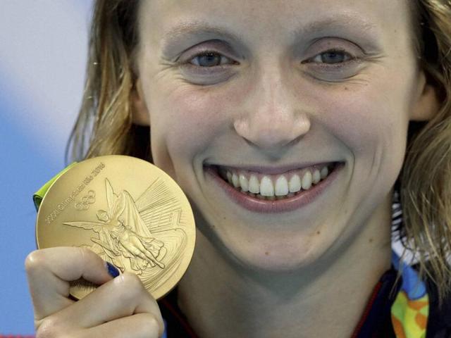 Katie Ledecky of the United States destroyed the field in the 800 metres freestyle on Friday, breaking her own world record to complete a rare Olympic swimming treble. (AP)