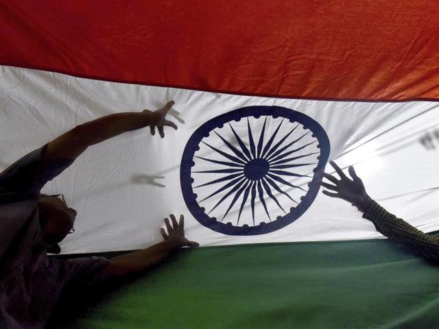 Men inspect the national flag before they pack it to sell at a workshop in Borivali, Mumbai. (Pratham Gokhale/HT photo) Men inspect the national flag before they pack it to sell at a workshop in Borivali, Mumbai. (Pratham Gokhale/HT photo)