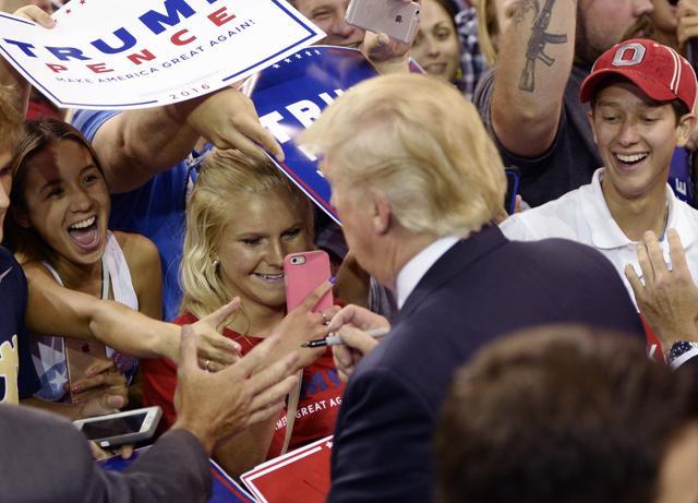 Spectators cheer as Donald Trump works the crowd following the Republican presidential candidate's rally at Erie Insurance Arena in Erie, Pa. (AP)