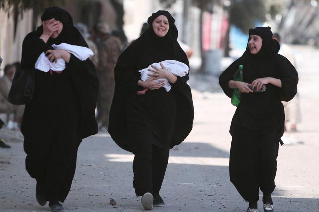 Women carry newborn babies while reacting after they were evacuated by the Syria Democratic Forces (SDF) fighters from Manbij. (REUTERS) Women carry newborn babies while reacting after they were evacuated by the Syria Democratic Forces (SDF) fighters from Manbij. (REUTERS)