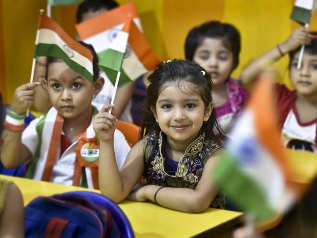 Students hold handmade national flags during celebrations of India's Independence Day at a school in New Delhi. (Raj K Raj/HT PHOTO)