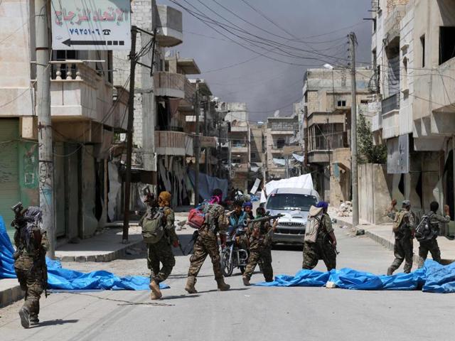 Members of the Syrian Democratic Forces (SDF) patrol a street in the northern Syrian town of Manbij on August 7, 2016, as they comb the city in search of the last remaining jihadists, a day after they retook it from the Islamic State group.(AFP)