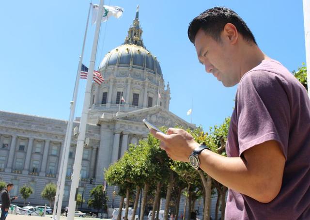 Two friends playing Pokemon Go a short distance away from the San Francisco City Hall. The US defense department has asked its employees not to download Pokemon Go app on their government-issued smartphones.(AFP)