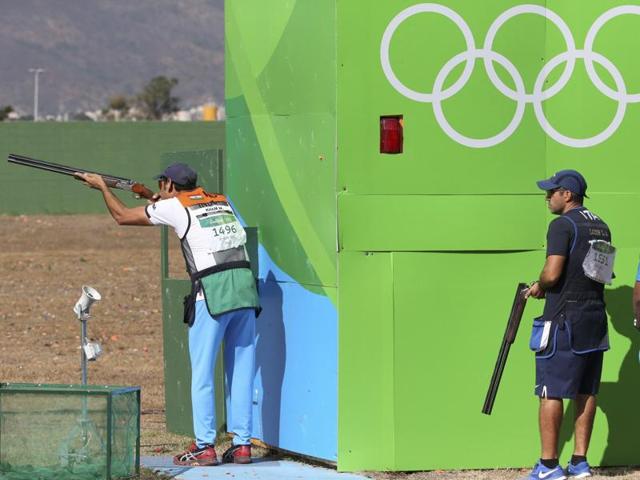 Mairaj Ahmad Khan (IND) of India competes as Luigi Lodde (ITA) of Italy watches. Khan failed to qualify for the skeet final. (REUTERS) 