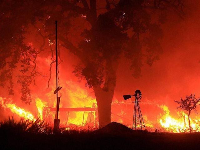 A two-story structure burns in a subdivision off Morgan Valley Road as a wildfire burns in Lower Lake, California. (AP Photo) A two-story structure burns in a subdivision off Morgan Valley Road as a wildfire burns in Lower Lake, California. (AP Photo)