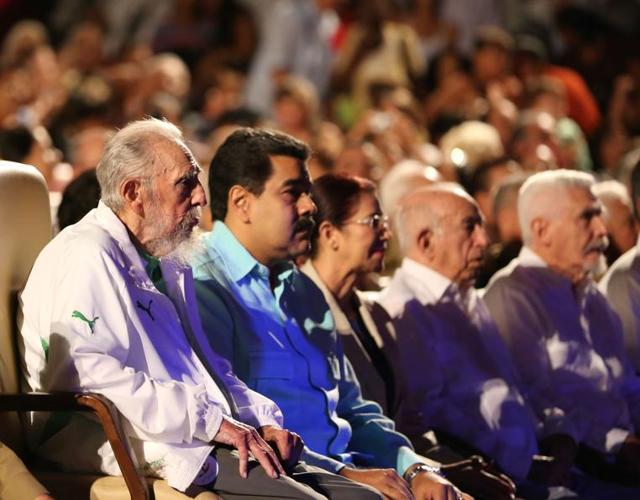 In this handout picture released by Prensa Miraflores, former Cuban President Fidel Castro (L), sitting next to Venezuelan President Nicolas Maduro (2nd L), is seen attending the celebration of his 90th birthday at the Karl Marx theatre in Havana on August 13, 2016.(AFP)