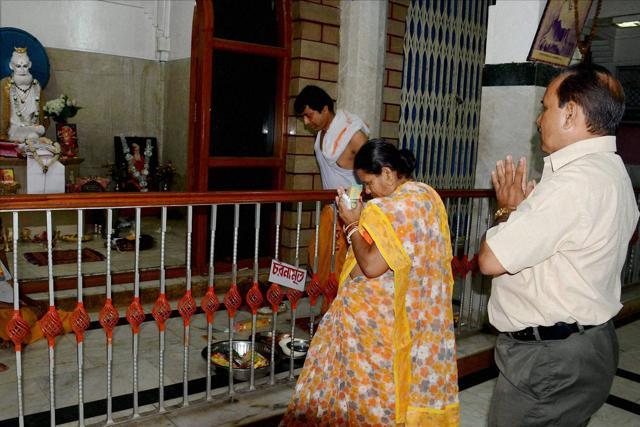 Gymnast Dipa Karmakar's parents pray at a temple in Agartala on Tuesday. (PTI) Gymnast Dipa Karmakar's parents pray at a temple in Agartala on Tuesday. (PTI)