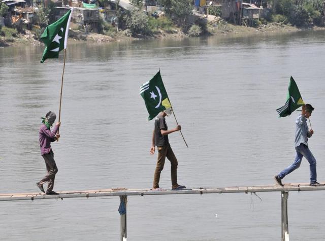 Kashmiri protesters hold Pakistani flags in Srinagar on Sunday. (Waseem Andrabi/HT Photo) Kashmiri protesters hold Pakistani flags in Srinagar on Sunday. (Waseem Andrabi/HT Photo)