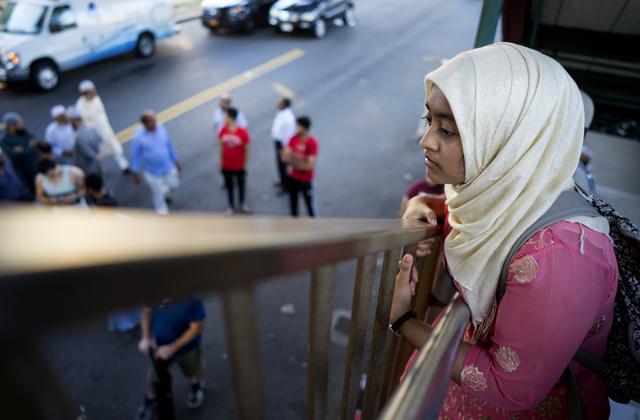 A woman looks over the area from the steps of an elevated train station Saturday in the Queens borough of New York, near a crime scene after the leader of a New York City mosque and an associate were fatally shot as they left afternoon prayers. (AP) A woman looks over the area from the steps of an elevated train station Saturday in the Queens borough of New York, near a crime scene after the leader of a New York City mosque and an associate were fatally shot as they left afternoon prayers. (AP)