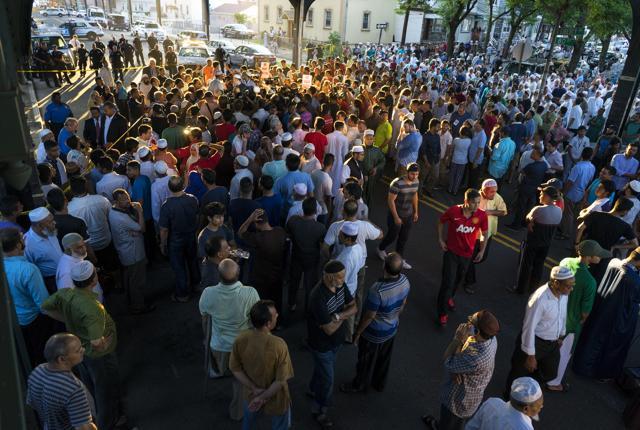 People gather for a demonstration in the Queens borough of New York on Saturday, near the crime scene. (AP)