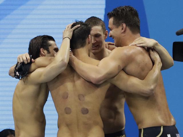 United States' Michael Phelps, second from left, celebrates with teammates after winning gold in the men's 4 x 100-meter medley relay final. (AP) United States' Michael Phelps, second from left, celebrates with teammates after winning gold in the men's 4 x 100-meter medley relay final. (AP)