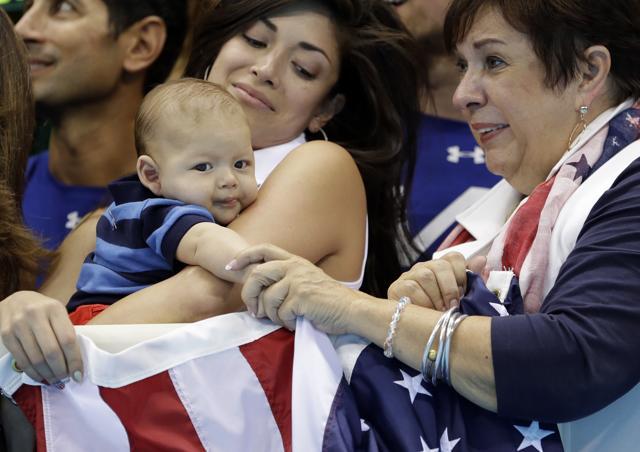Nicole Johnson, fiance of United States' Michael Phelps, holds their baby Boomer, as she stands with Phelps' mother Debbie during the men's 4 x 100-meter medley relay final during the swimming competitions at the 2016 Summer Olympics. (AP) Nicole Johnson, fiance of United States' Michael Phelps, holds their baby Boomer, as she stands with Phelps' mother Debbie during the men's 4 x 100-meter medley relay final during the swimming competitions at the 2016 Summer Olympics. (AP)