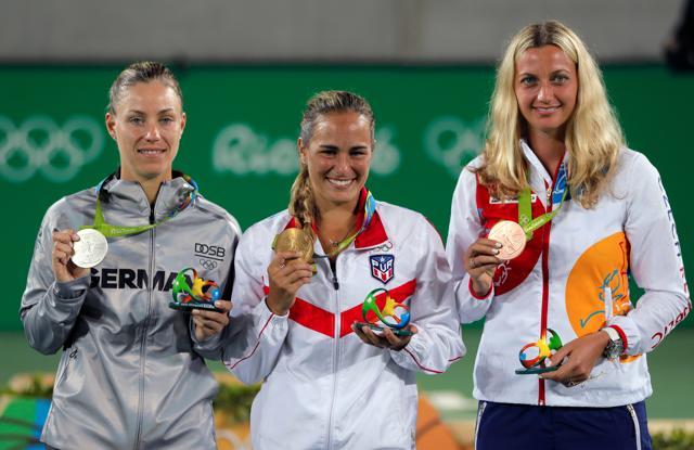 Monica Puig of Puerto Rico, centre, winner of the gold medal, Germany's Angelique Kerber, left, winner of the silver medal and Petra Kvitova of the Czech Republic, winner of the bronze medal pose after the medals ceremony. (AP) Monica Puig of Puerto Rico, centre, winner of the gold medal, Germany's Angelique Kerber, left, winner of the silver medal and Petra Kvitova of the Czech Republic, winner of the bronze medal pose after the medals ceremony. (AP)