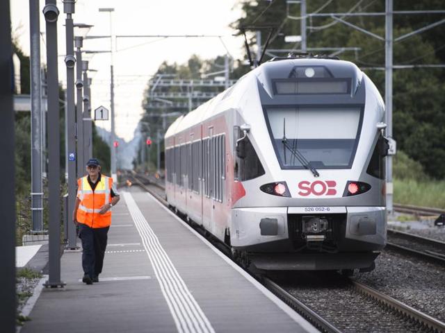 Workers clean a platform after a 27-year-old Swiss man's attack on a Swiss train at the railway station in the town of Salez, Switzerland on Saturday.(Reuters)