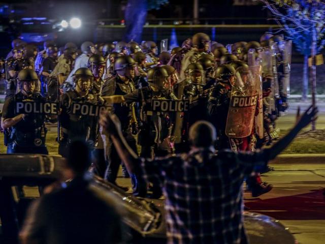 Police move in on a group of protesters throwing rocks at them in Milwaukee, Sunday, Aug. 14, 2016. (AP Photo) Police move in on a group of protesters throwing rocks at them in Milwaukee, Sunday, Aug. 14, 2016. (AP Photo)