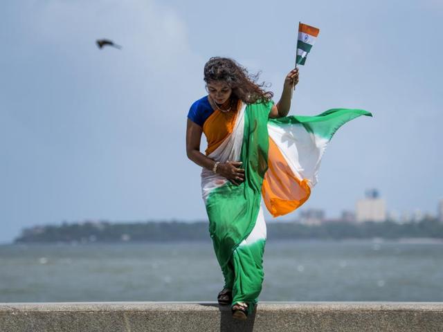 A woman draped in a saree with the colours of the national flag at Marine Drive in Mumbai on Monday. (satish bate/ ht photo) 