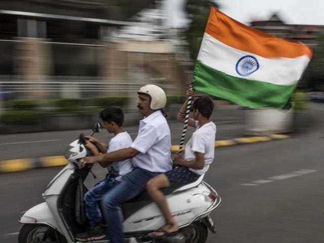 Pride ride: With the tricolour fluttering away in Mumbai air, a family celebrate Independence Day on Monday.  (Satish Bate//HT Photo) 