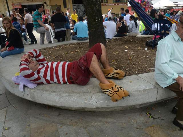 A man rests in a park during lazy-day celebrations. (AFP) A man rests in a park during lazy-day celebrations. (AFP)