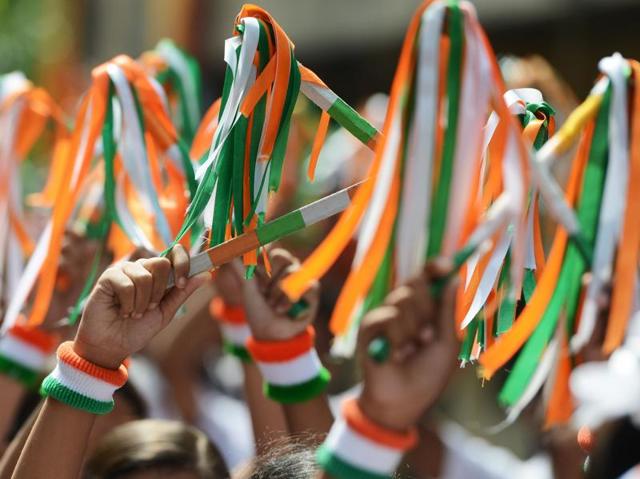 Schoolchildren with tricolour bands on their wrists participate in a drill for Independence Day celebrations at a school in Kolkata.   (AFP/ Dibyangshu SARKAR) 