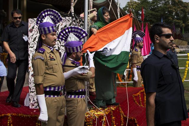 Jammu and Kashmir state CM Mehbooba Mufti holds the national flag after it fell during the unfurling ceremony. (AP) Jammu and Kashmir state CM Mehbooba Mufti holds the national flag after it fell during the unfurling ceremony. (AP)