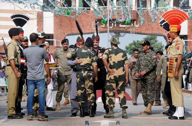 Pakistani Rangers sector commander Shaukat Ali hugs Border Security Force (BSF) commandant Sudeep (R) before presenting sweets baskets on the occasion of Pakistan's Independence Day at the Attari-Wagah border on Sunday. (PTI) Pakistani Rangers sector commander Shaukat Ali hugs Border Security Force (BSF) commandant Sudeep (R) before presenting sweets baskets on the occasion of Pakistan's Independence Day at the Attari-Wagah border on Sunday. (PTI)