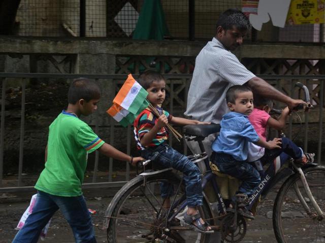 A child carries a bunch of flags at Hiranandani in Powai, Mumbai,  on Monday.India, on Monday. (Prashant waydande/ht photo) 