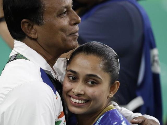 India's Dipa Karmakar hugs her coach after performing on the vault. (AP) 